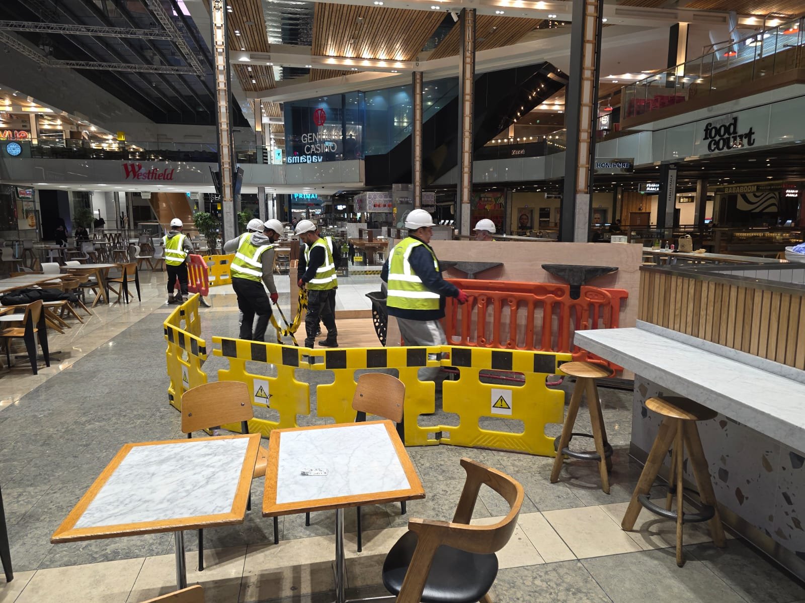ECL crew installing barriers and works in live food court