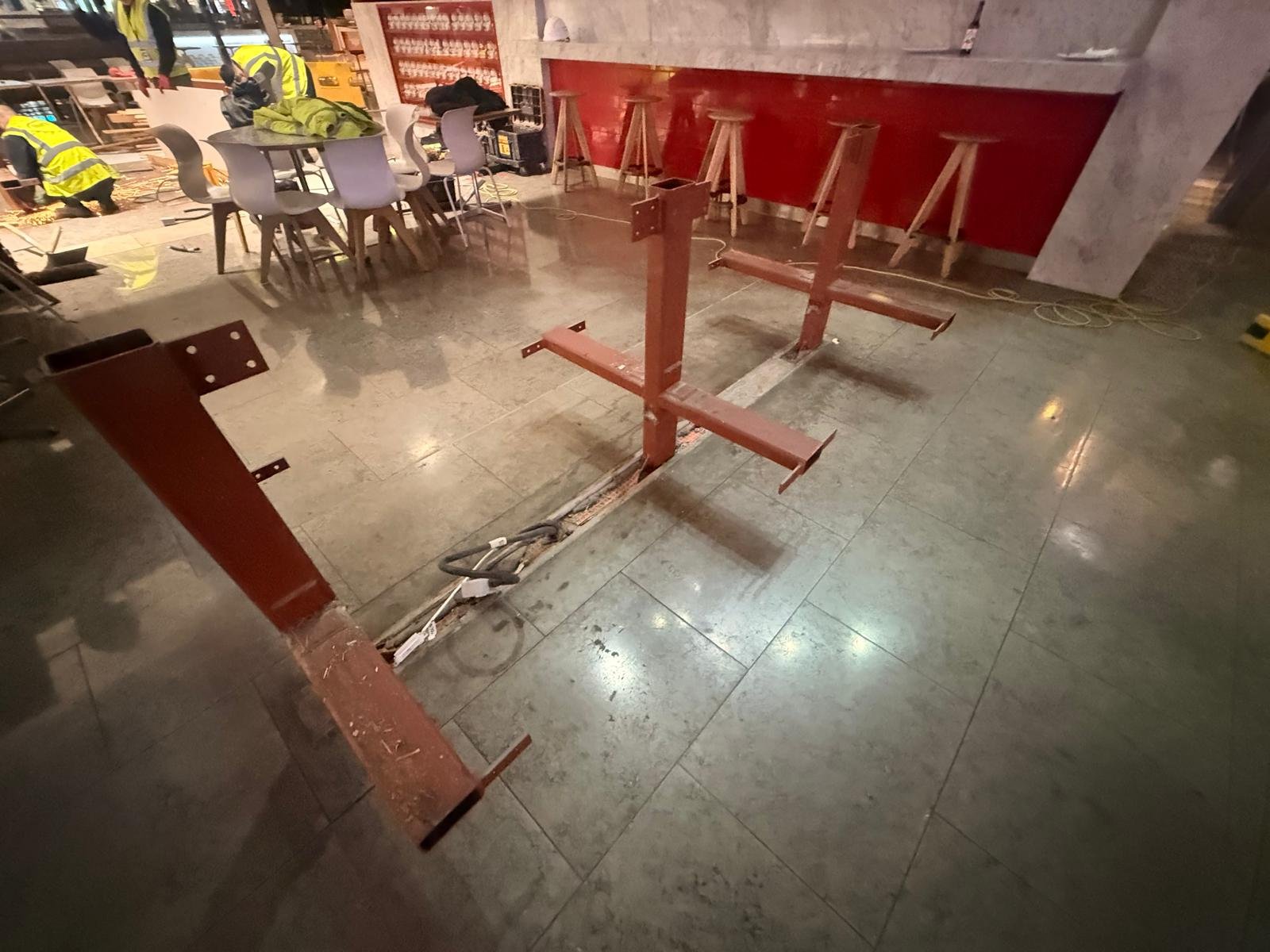 Structural steel base plates set into food court floor