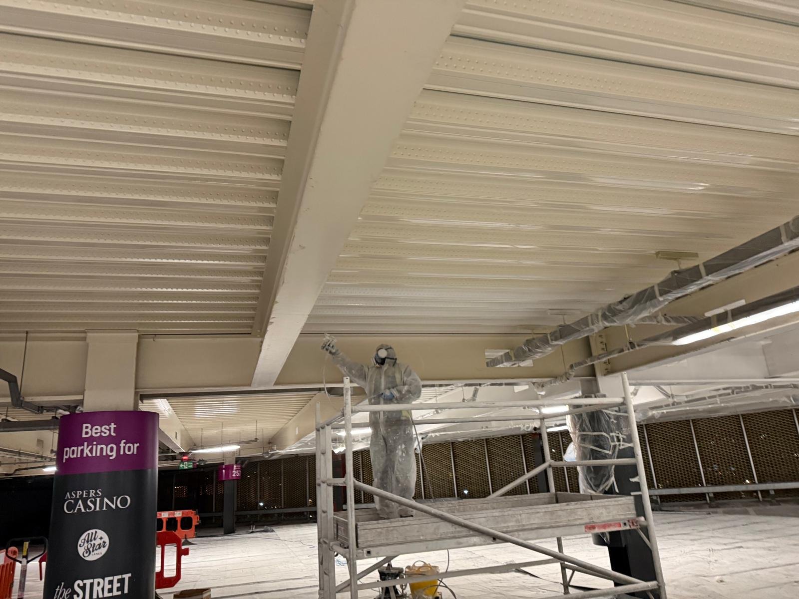 Spray-applied protective coating to fire-damaged ceiling beams