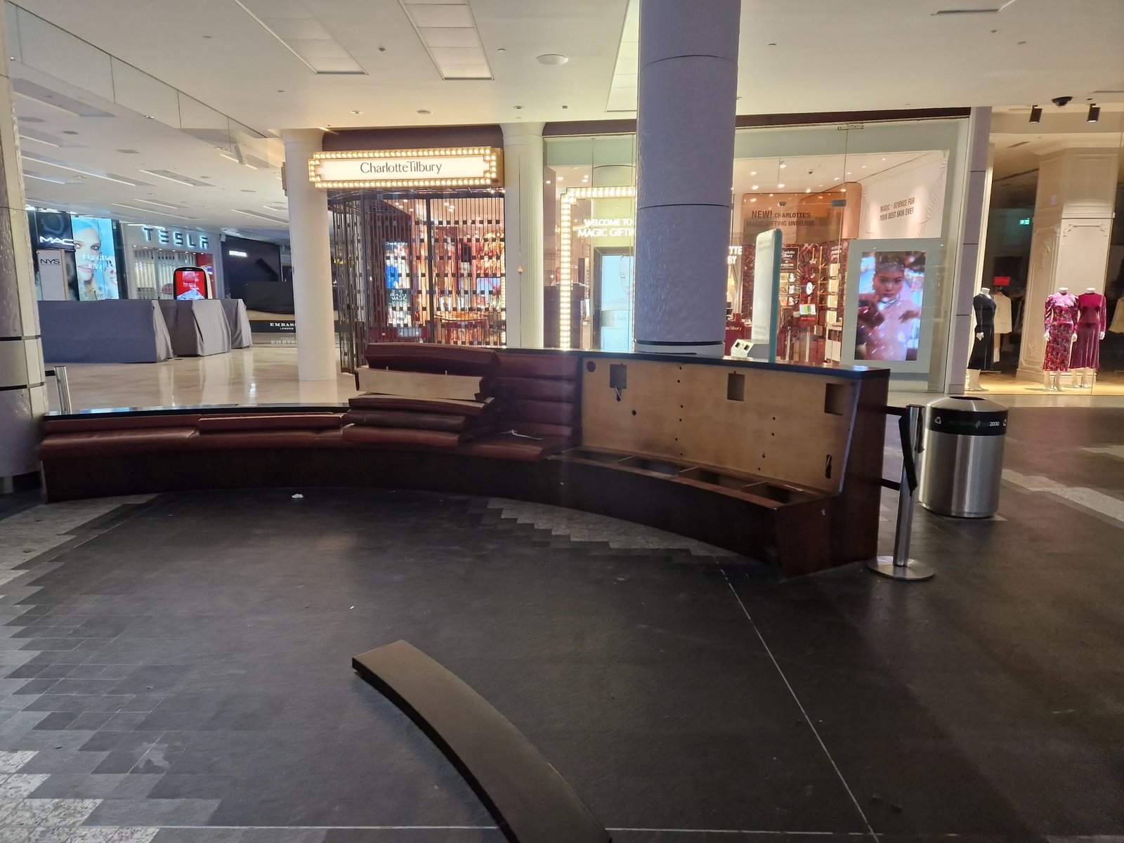 Exposed plywood kiosk carcass mid-removal