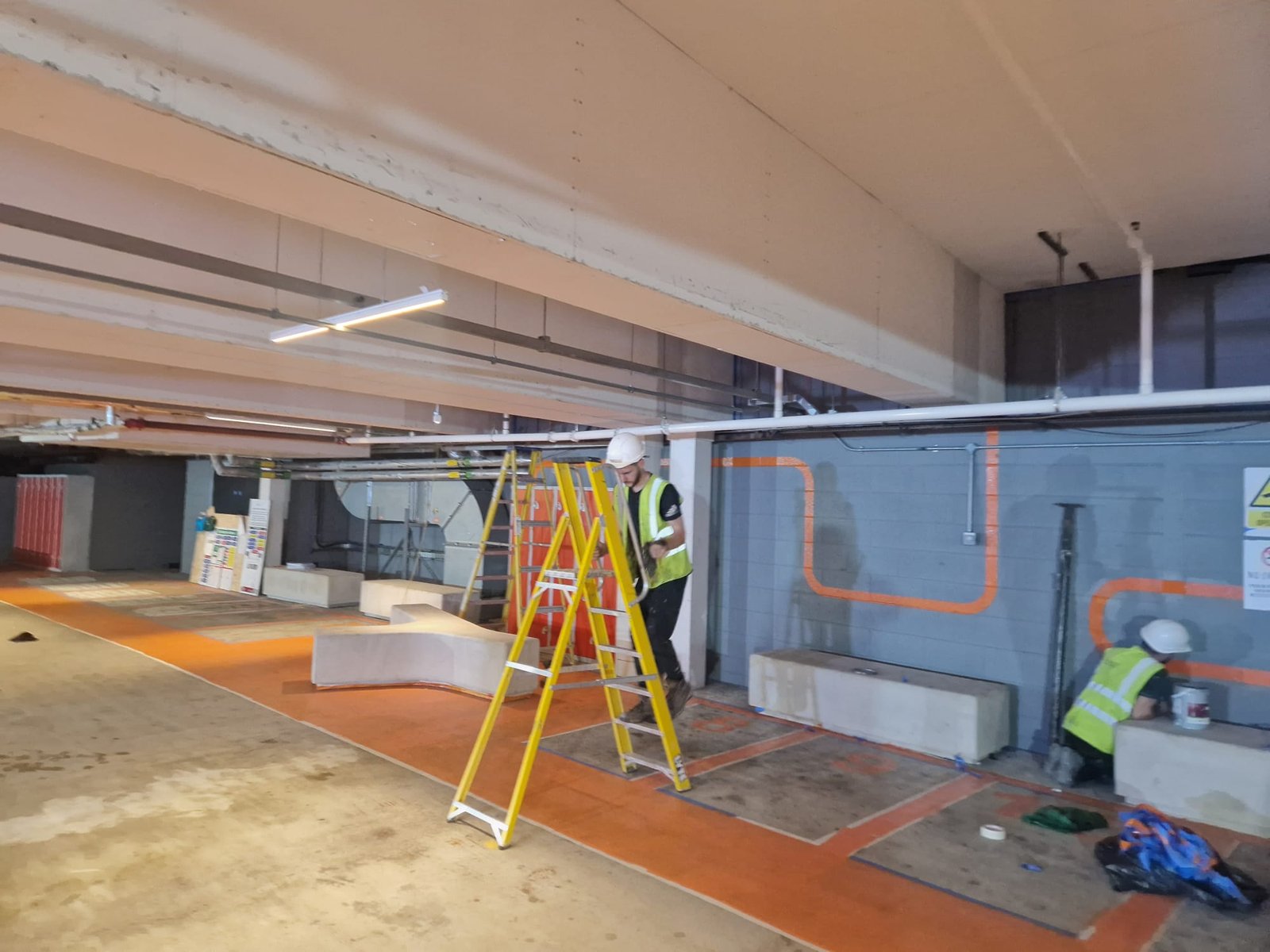 Operatives applying wall and floor paint to brand standard