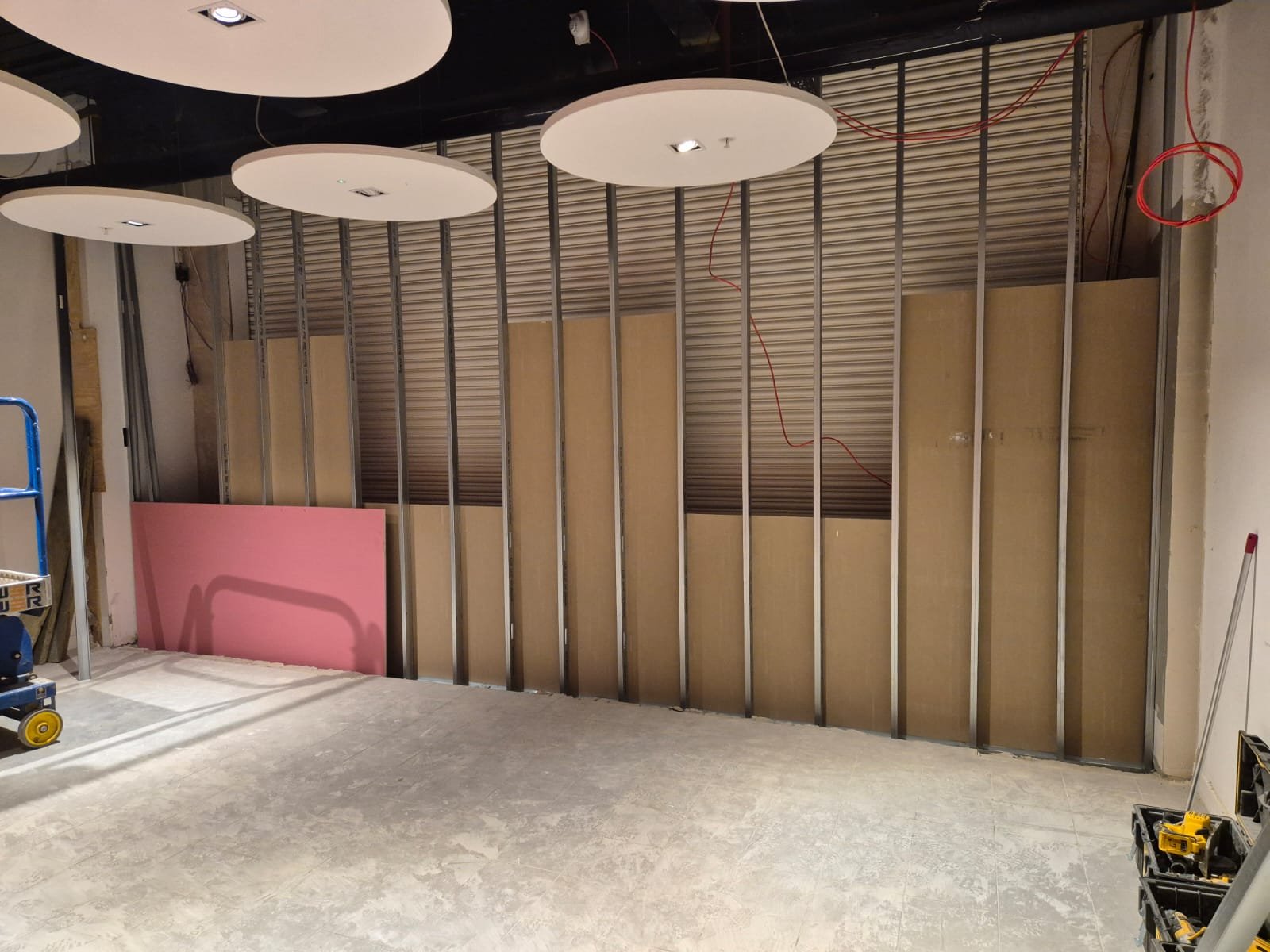 Metal stud framing with circular acoustic ceiling rafts