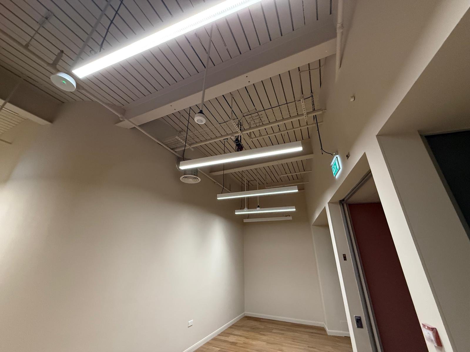 Finished ceiling with linear lighting and services