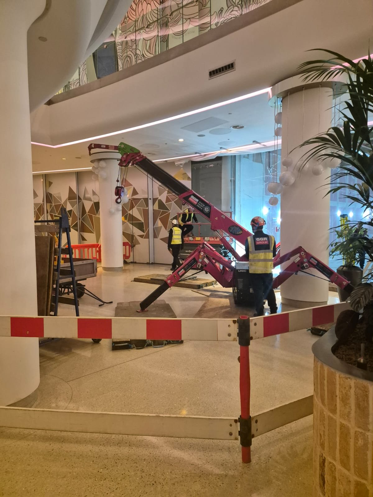 Spider crane positioned in mall for glazing works