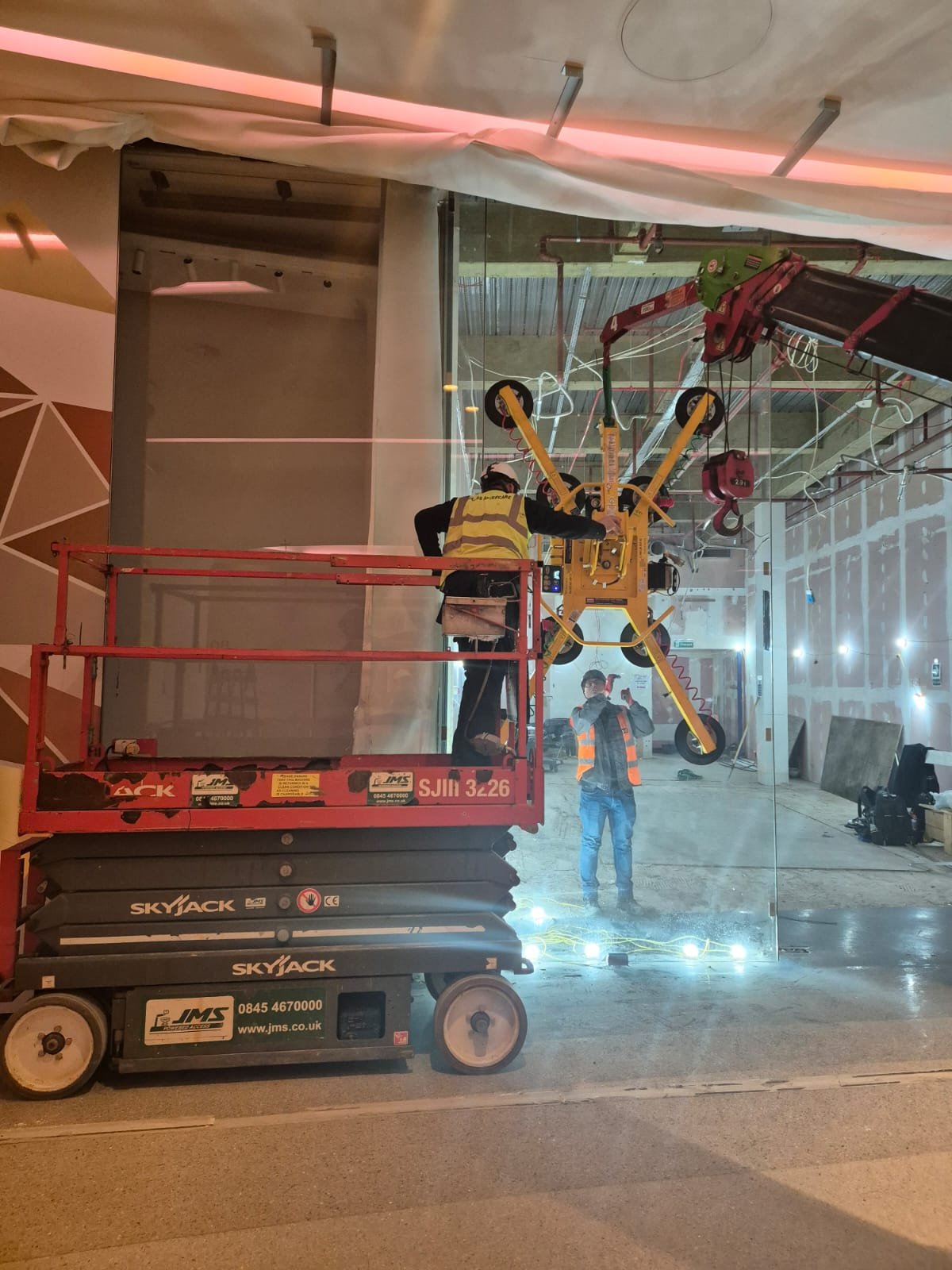 Glass panel manipulator removing shopfront pane