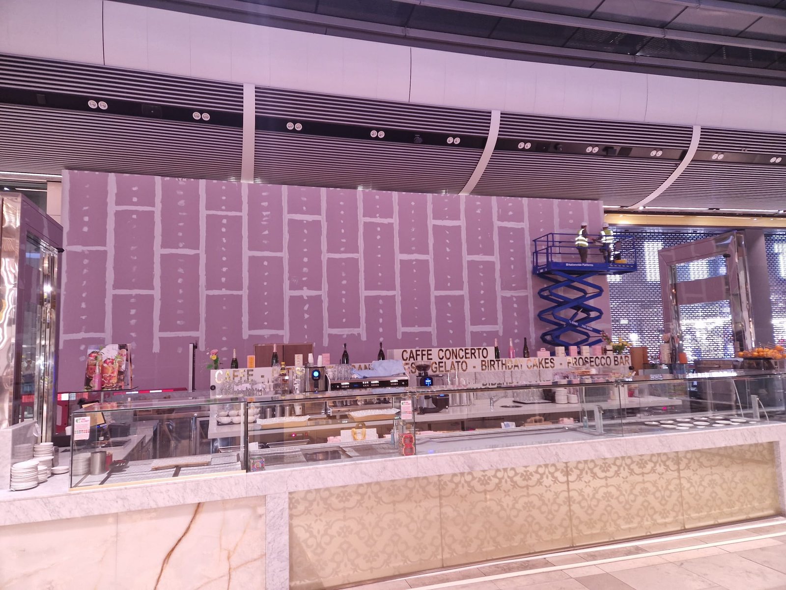 Hoarding behind Caffè Concerto in food court