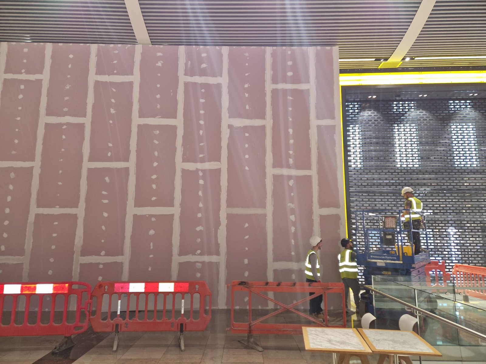 Tall hoarding wall with taped joints ready for finish