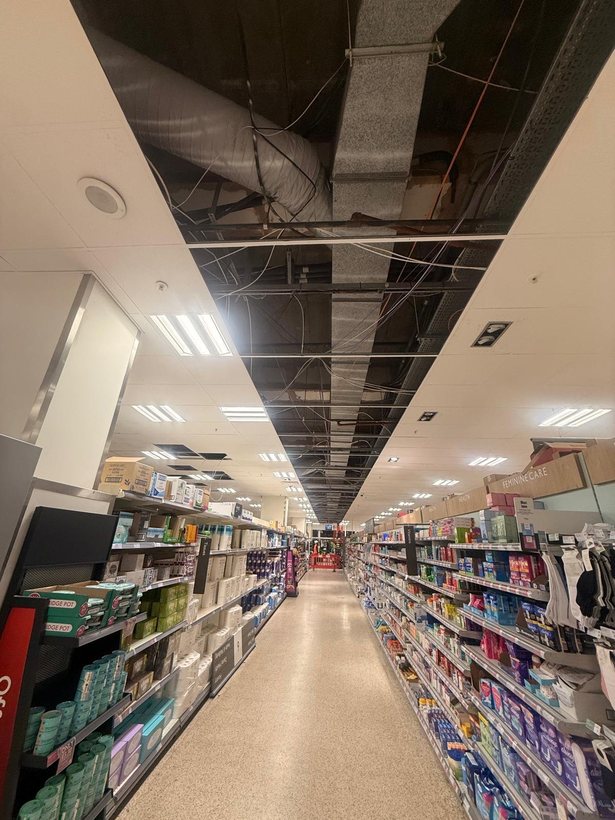Ceiling reinstatement progress above tissue and health aisles